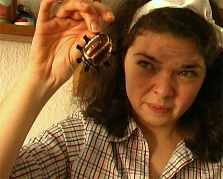 junge Frau hlt einen Schoko-Maikfer mit spitzen Fingern ©Marlene Denningmann